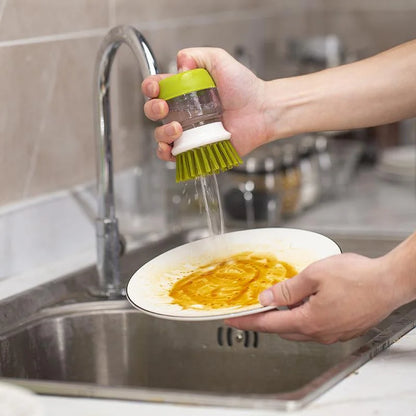 Washing-up brush with soap dispenser